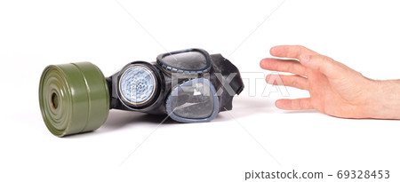 Arm reaching for vintage gasmask isolated on white - Green filte Arm reaching for vintage gasmask isolated on white - Green filte 69328453