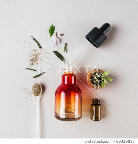 Bottle with pipette and herbal ingredients, natural cosmetics concept 69329855