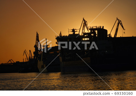 Harbor and Cranes against red sunset background 69330160