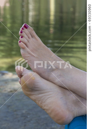 Feet of woman resting on the river 69330960
