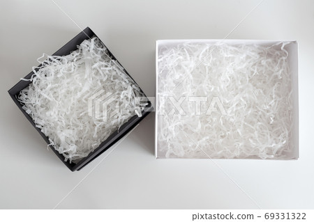 Opened gift boxes with decorative straw, filler, shavings. paper box for your product placement or montage. Presents wrapping. Top view, flat lay 69331322