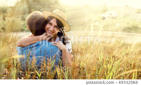 Young girl with her boyfriend on a walk outside the city. 69332068