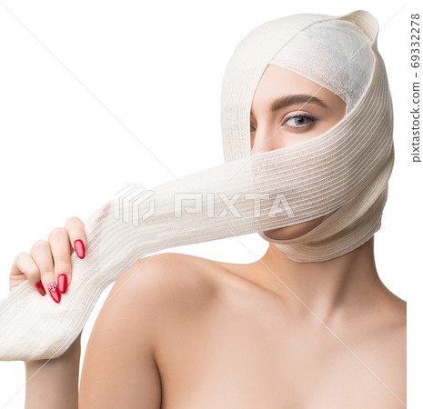 Beautiful woman with bandaged face after plastics Beautiful woman with bandaged face after plastics 69332278