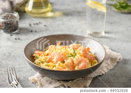 Italian pasta fettuccine with shrimps on gray. Italian pasta fettuccine with shrimps on gray. 69332826