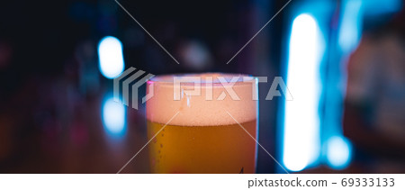 Beer poured into glasses in the bar at night. Beer poured into glasses in the bar at night. 69333133