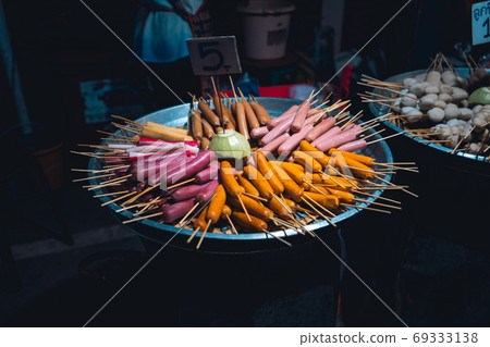 Meatballs and skewers are sold in the market. Meatballs and skewers are sold in the market. 69333138