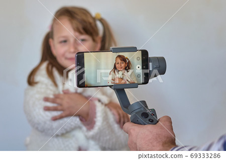 blonde girl with a white rabbit in her arms 69333286