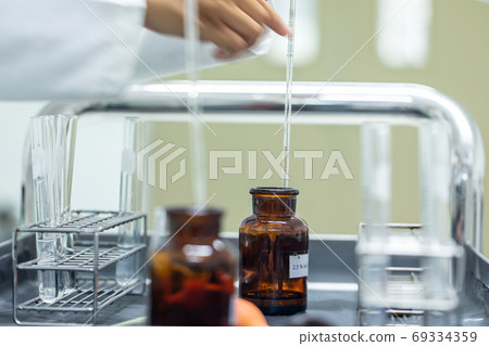 Sample analysis using Spectrophotometer for lab experiments. 69334359