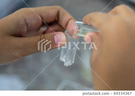 Sample analysis using Spectrophotometer for lab experiments. Sample analysis using Spectrophotometer for lab experiments. 69334367