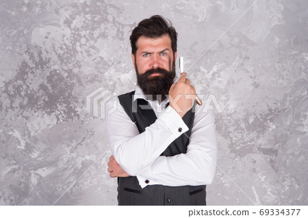 Bearded man hold vintage razor. You get deep and clean Bearded man hold vintage razor. You get deep and clean 69334377