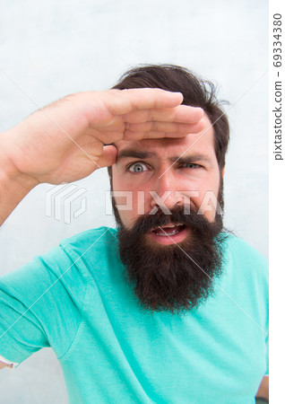 Suspicious look. Man bearded hipster stylish beard grey background. Perceptions of male beauty. Suspicious look. Man bearded hipster stylish beard grey background. Perceptions of male beauty. 69334380