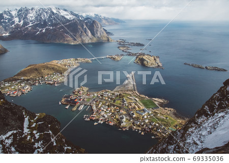 Scenic landscape of Lofoten islands: peaks, lakes, and houses. Reine village, rorbu, reinbringen 69335036