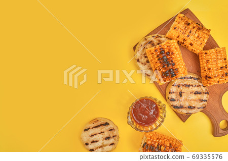 grilled corn vegetables on a yellow background, copy space, flatlay grilled corn vegetables on a yellow background, copy space, flatlay 69335576