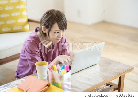 Young woman working from home Young woman working from home 69335633