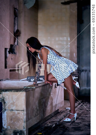 Young model sitting on the bath in ruined hotel Young model sitting on the bath in ruined hotel 69335748
