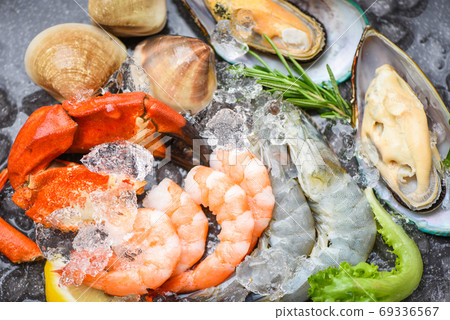 Fresh raw seafood buffet with lemon rosemary ingredients herb an 69336567