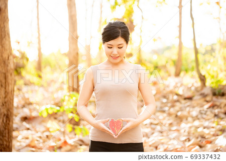Women's health image Fallen leaves forest and heart 69337432