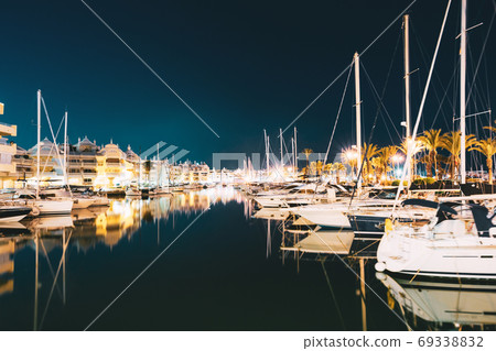 Benalmadena, Spain. Night Scenery View Of Marina, Vessel In Puerto Marina. Malaga Region, On The Costa Del Sol. It Caters For A Large Number Of Tourists. Benalmadena, Spain. Night Scenery View Of Marina, Vessel In Puerto Marina. Malaga Region, On The Costa Del Sol. It Caters For A Large Number Of Tourists. 69338832
