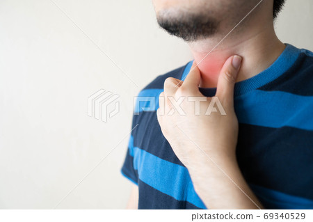 Sick man suffering from sore throat. Causes of throat pain include flu, common cold, respiratory tract infections, allergies or GERD. Health care and medical concept. Close up. Copy space. Sick man suffering from sore throat. Causes of throat pain include flu, common cold, respiratory tract infections, allergies or GERD. Health care and medical concept. Close up. Copy space. 69340529