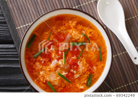 Spicy tasty tomato egg drops soup close-up in a bowl. horizontal Spicy tasty tomato egg drops soup close-up in a bowl. horizontal 69342249