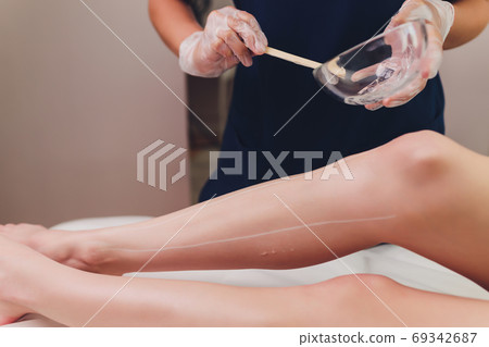 Beautician Giving Epilation Laser Treatment To Woman On Thigh. 69342687