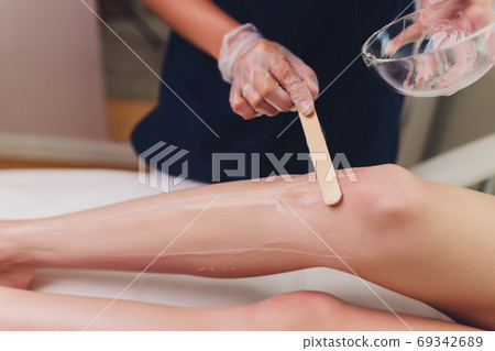 Beautician Giving Epilation Laser Treatment To Woman On Thigh. Beautician Giving Epilation Laser Treatment To Woman On Thigh. 69342689