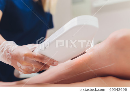 Laser hair removal on ladies legs. Intentional shallow depth of field. 69342696