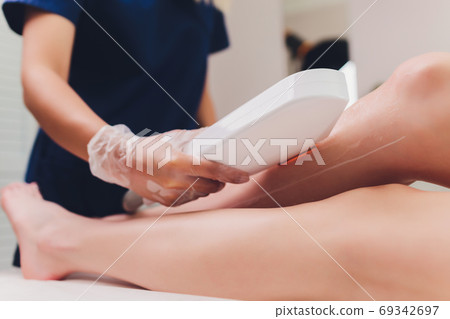 Laser hair removal on ladies legs. Intentional shallow depth of field. 69342697