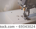 Industrial flat-seam sewing machine. Soft focus 69343024