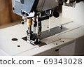 Industrial flat-seam sewing machine. Soft focus 69343028