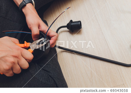 Chandelier with wires and tools on the floor, preparation to installation. 69343038