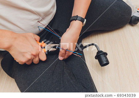 Chandelier with wires and tools on the floor, preparation to installation. 69343039