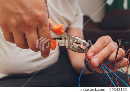 Chandelier with wires and tools on the floor, preparation to installation. Chandelier with wires and tools on the floor, preparation to installation. 69343183