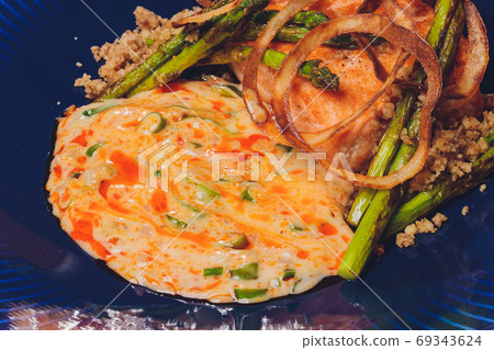 Cooked salmon fillets with dill sauce on white plate. Cooked salmon fillets with dill sauce on white plate. 69343624