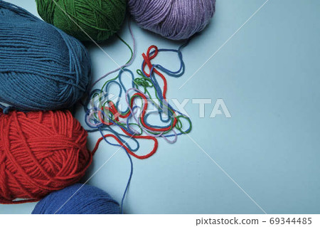 Group of various yarn balls and knitting needles closeup 69344485