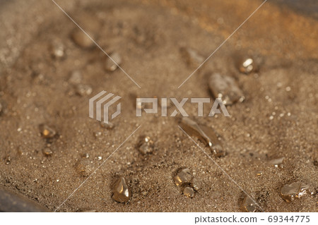 Golden nuggets on grungy wash pan with sand Golden nuggets on grungy wash pan with sand 69344775