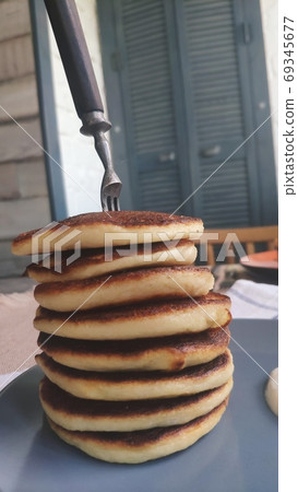 Plate with stack of homemade pancakes and sour cream on wooden table, selective focus 69345677