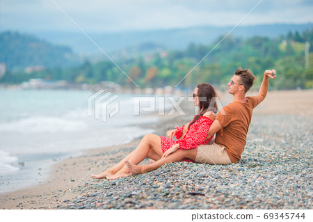 Young couple on white beach during summer vacation. Young couple on white beach during summer vacation. 69345744