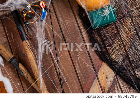 Fishing tacles on wooden background in Halloween designe with sp Fishing tacles on wooden background in Halloween designe with sp 69345799