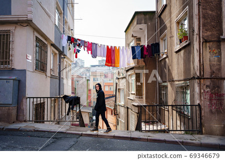 Teenager glasses on background of drying clothes 69346679
