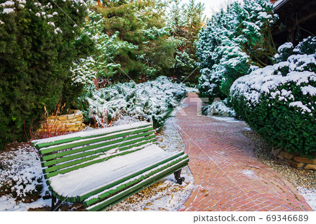 Green Bench covered with snow. 69346689