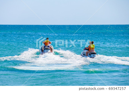 a man rides a jet ski in the open sea 69347257