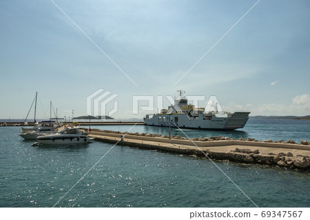 Ferry sailing between Orebic and Korcula island.  69347567