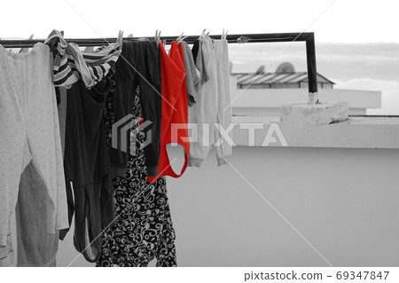 a lot of clothes hunging to be dryed a lot of clothes hunging to be dryed 69347847