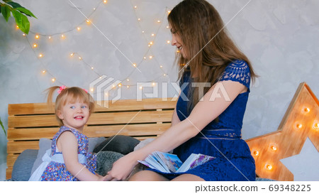 Portrait of funny little girl and her mother at home Portrait of funny little girl and her mother at home 69348225