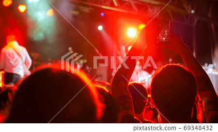 Hand silhouette recording video of live music concert with smartphone Hand silhouette recording video of live music concert with smartphone 69348432