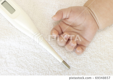 Two month old baby's hand and digital thermometer Two month old baby's hand and digital thermometer 69348657