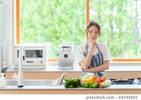 Woman thinking in the kitchen Woman thinking in the kitchen 69348805