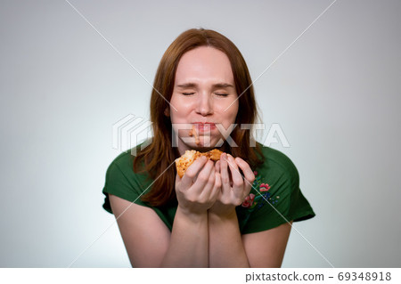 Woman with food in their mouth eating pizza, laugh Woman with food in their mouth eating pizza, laugh 69348918
