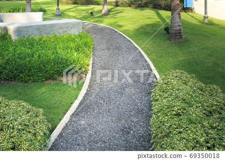 Walkway and bush in garden. 69350018